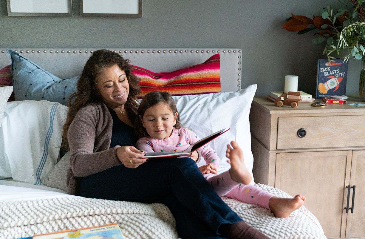 Mother-annd-daughter-reading-a-story-in-bedroom-of-a-new-home