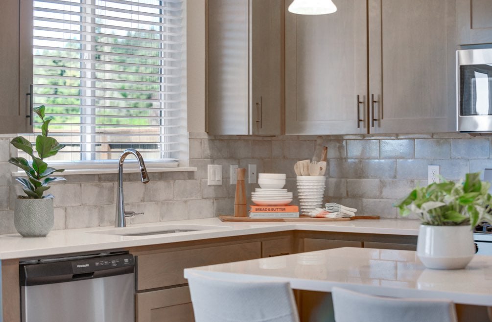 Plants on kitchen counter in new home by Holt