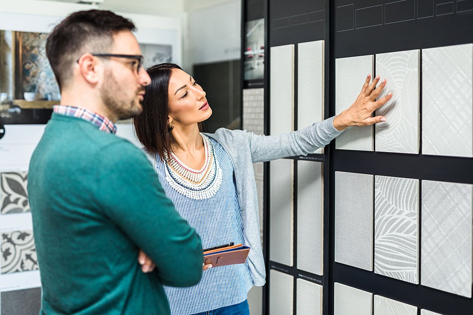 Young-man-picking-tile-options-for-his-new-home