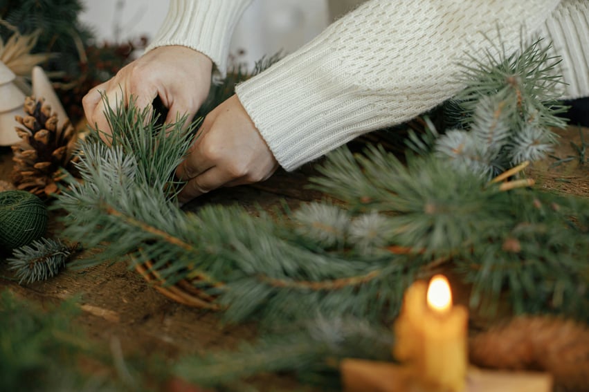 person handmaking a wreath